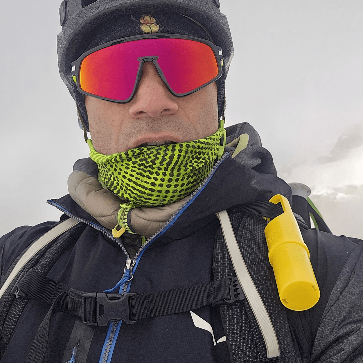 Montañista con Nomad Face Bunker Yellow Sunrise en la mochila, protector solar mineral para condiciones extremas.