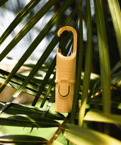 "Bunker Nomad Face Yellow Sunset – protector solar recargable para deportes outdoor, ideal para climas cálidos y tropicales."