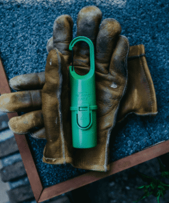 Green Forest de Nomad Face sobre guantes de trabajo, símbolo de protección en movimiento.