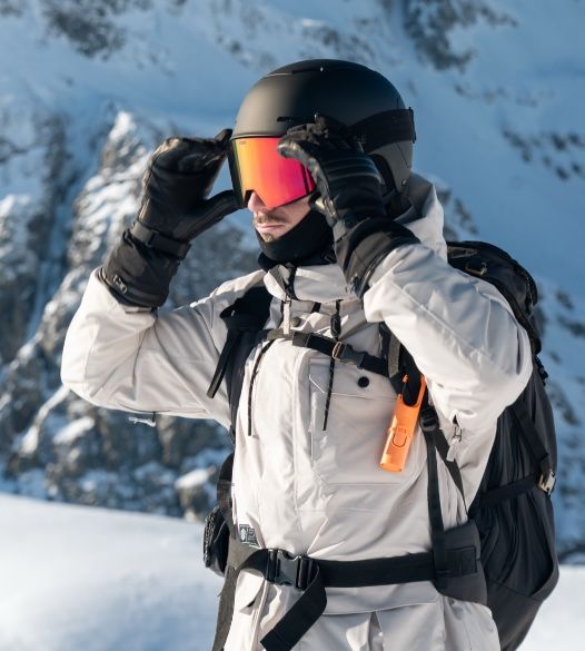deportista en montaña con gafas protegiéndose del sol en invierno Escoger una proteccion solar para deportistas especificamente es clave